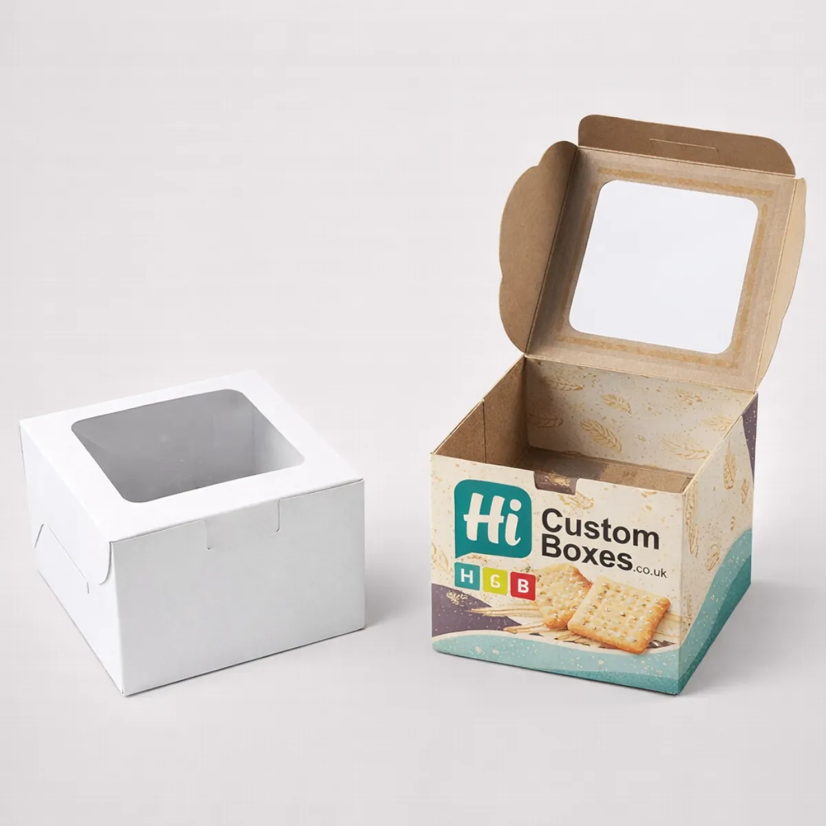 Cardboard cracker boxes with top viewing windows- showcasing wheat-themed designs and a plain version- class=